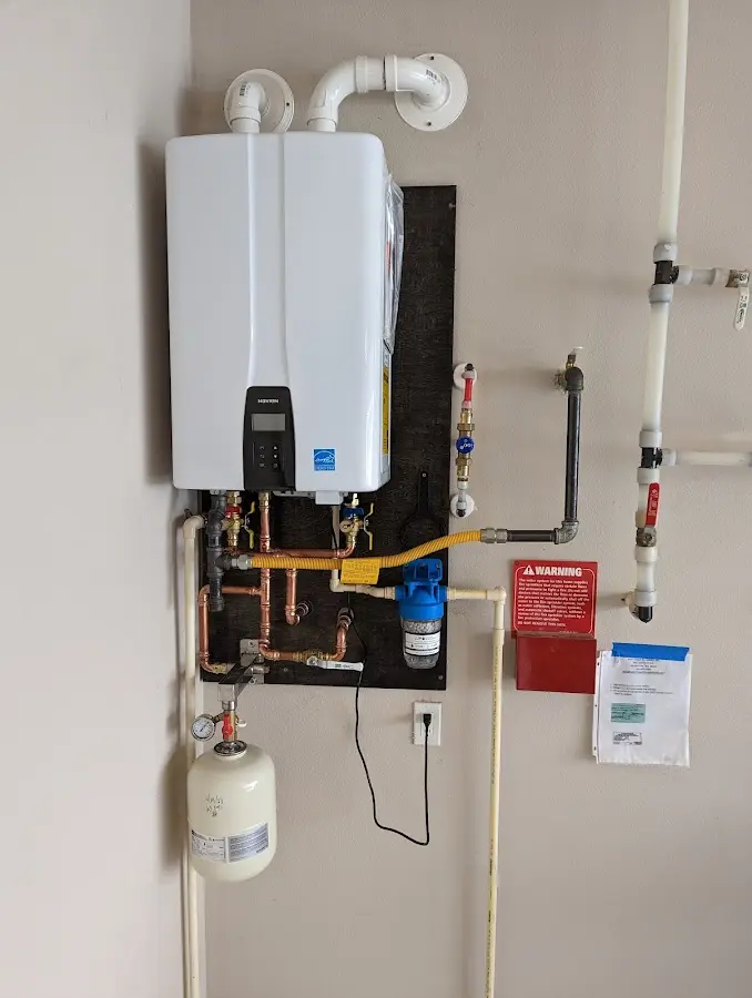 Professional plumber installing copper piping in a Nantucket home